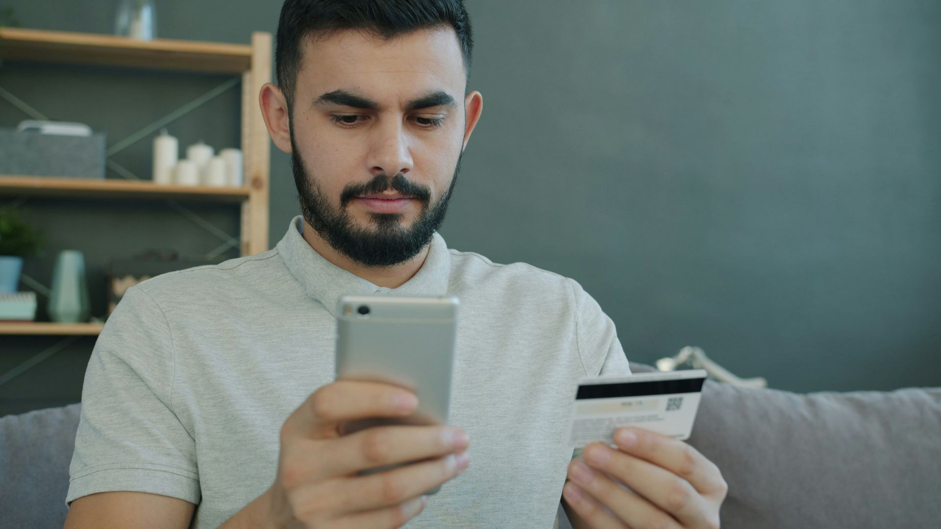 Man holding phone and credit card for online shopping
