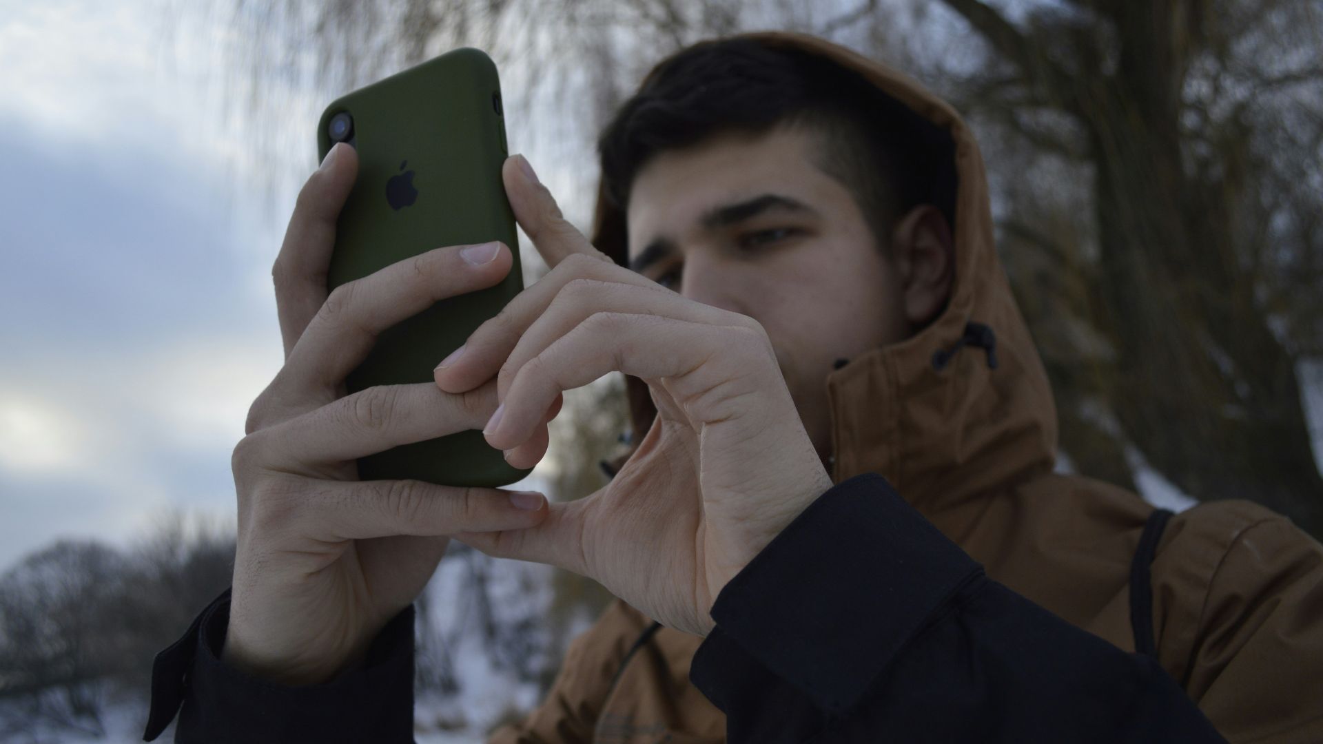 a man holding a cell phone up to his face