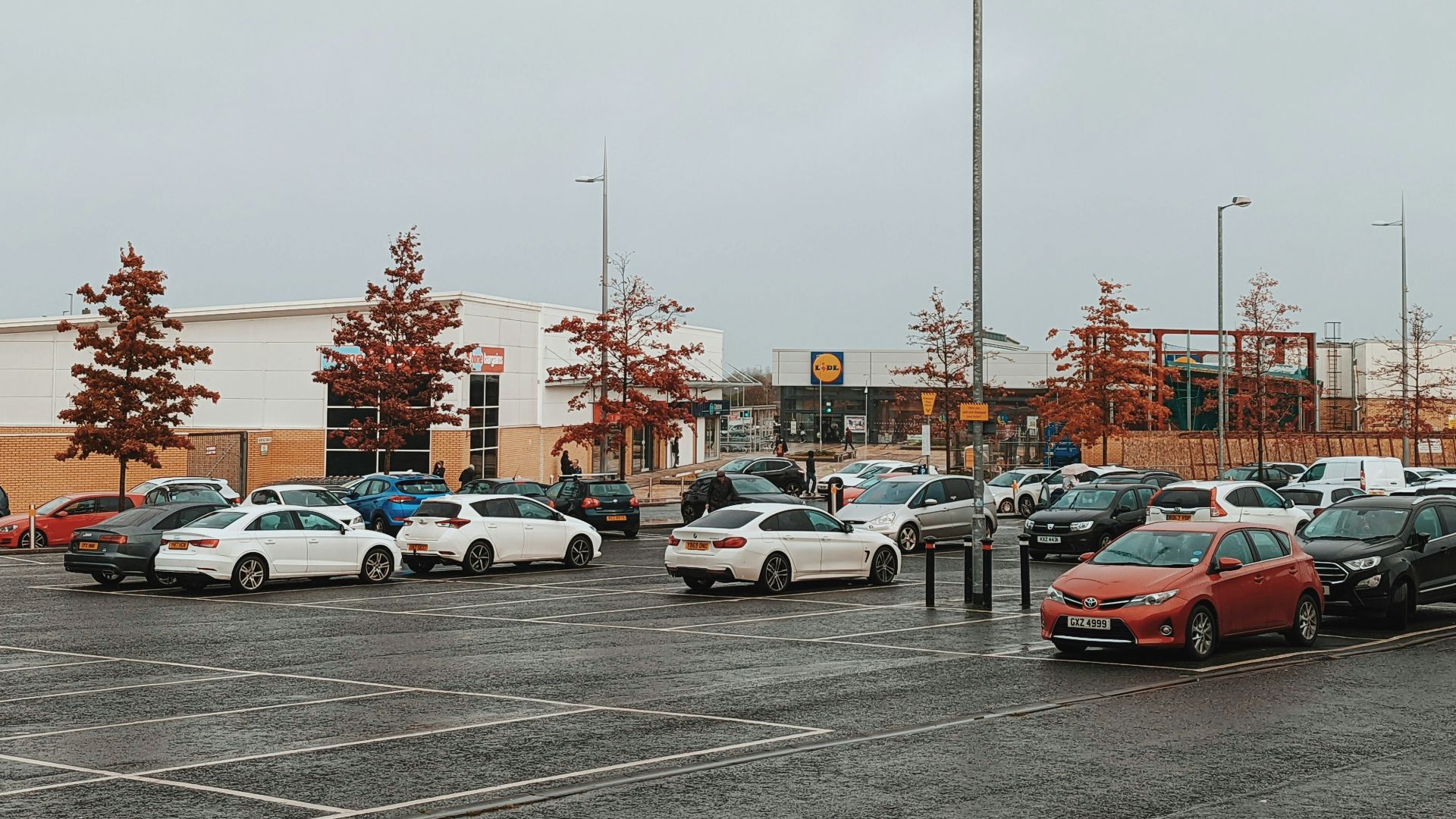 a parking lot filled with lots of parked cars