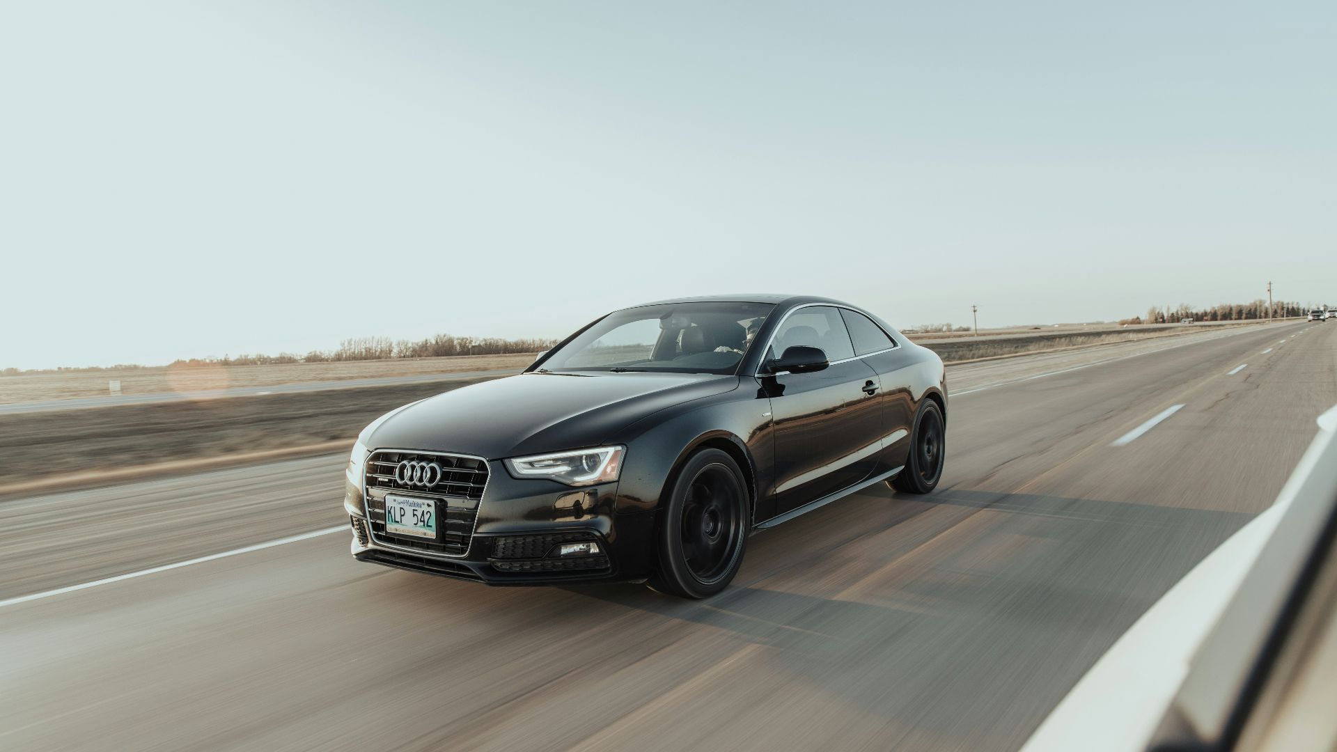 black audi sedan on road during daytime
