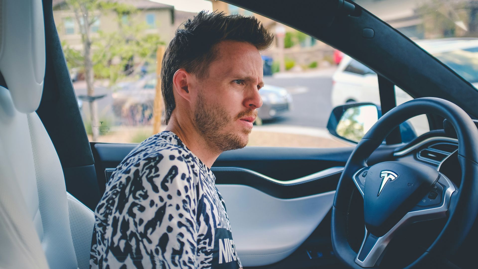 man sitting on car front seat
