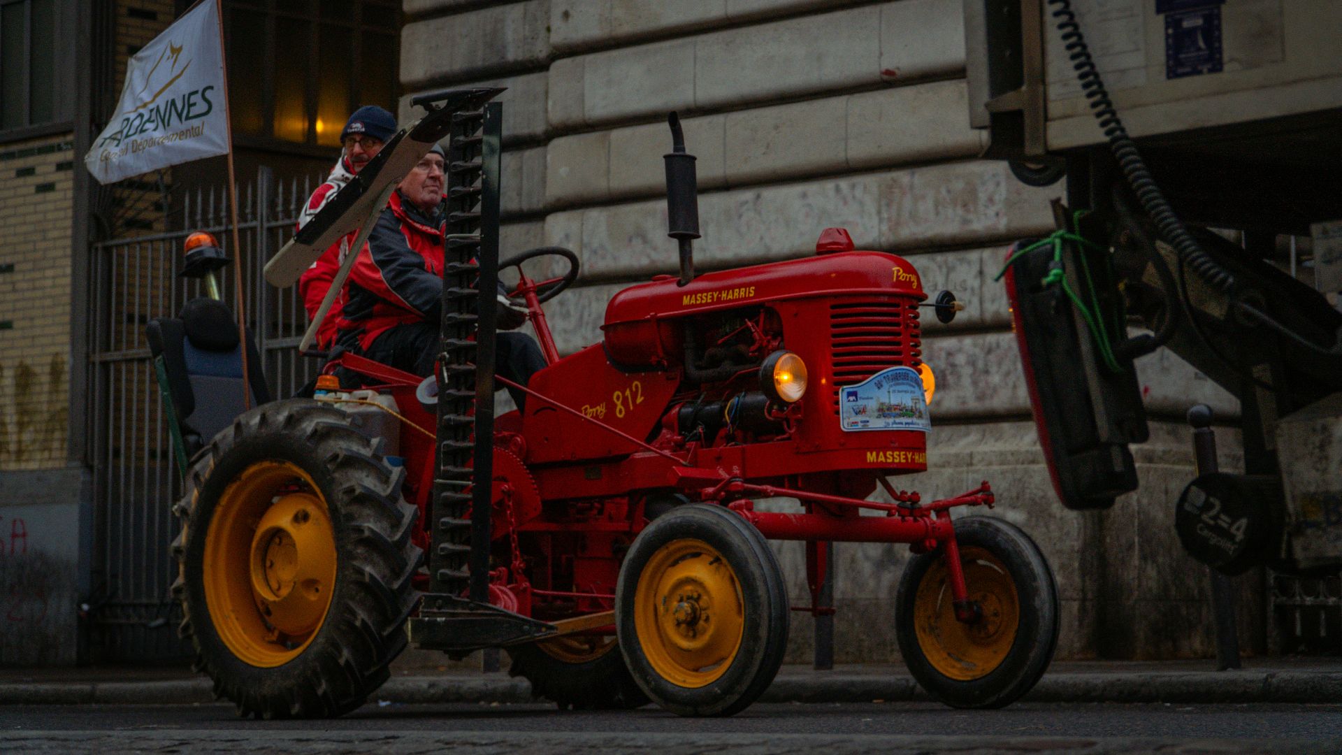 Red vintage tractor with a person driving