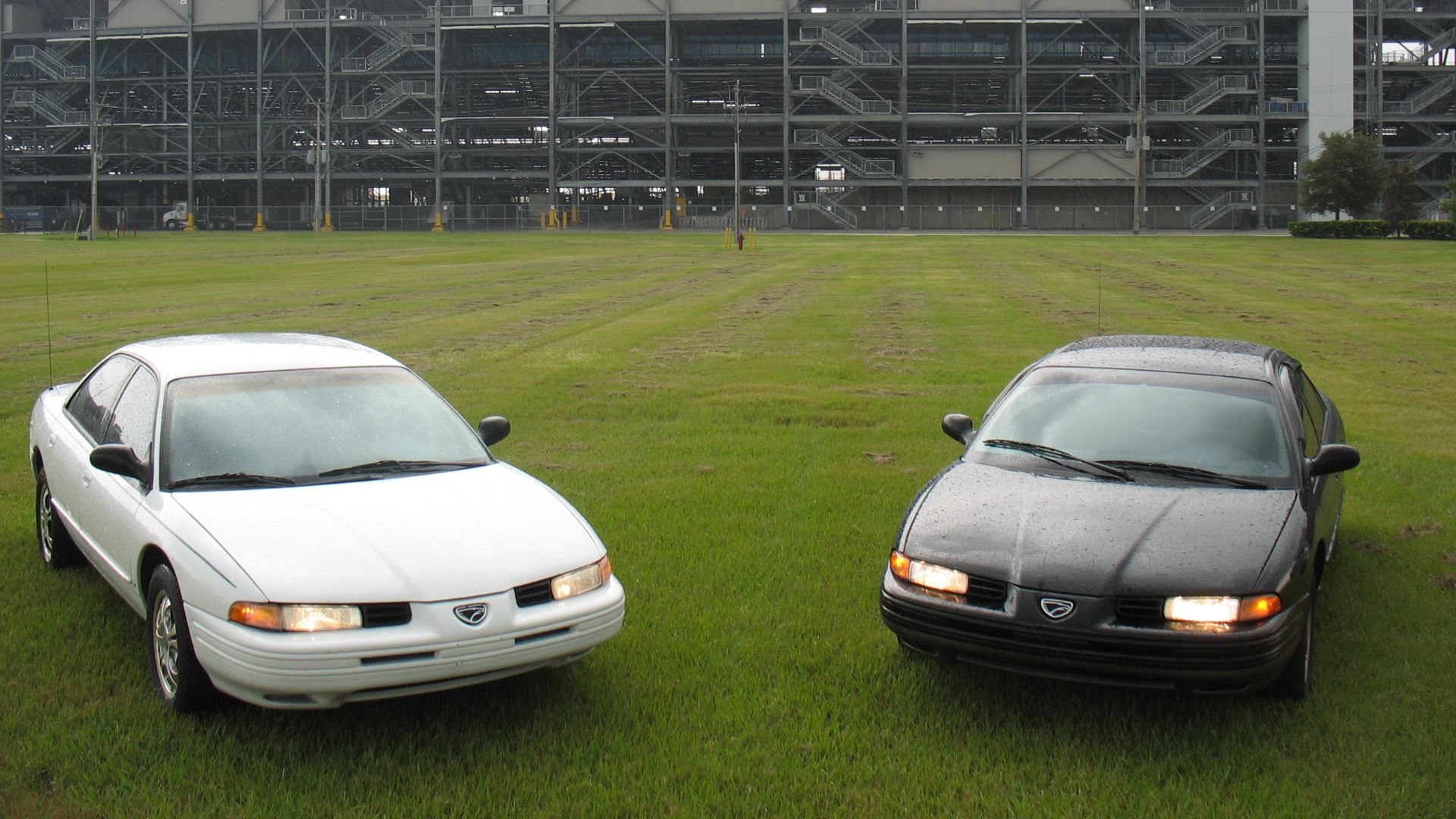 White 93 Eagle Vision with Aftermarket Chrome Rims and 94 Eagle Vision Esi with optional Vent Visor on Daytona Speedways.
