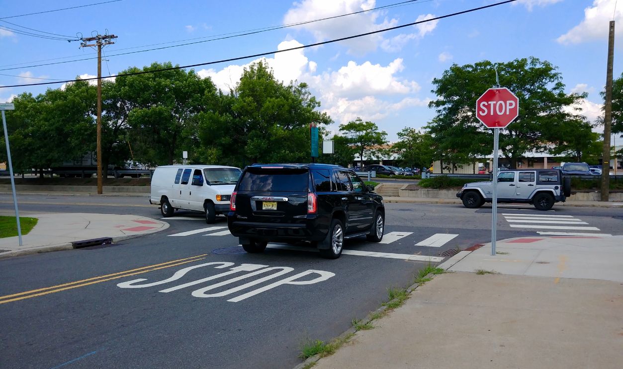 Jersey City, NJ - August 8 2019: A car stopped at a stop sign at the intersection of 16th Street and Marin Boulevard
