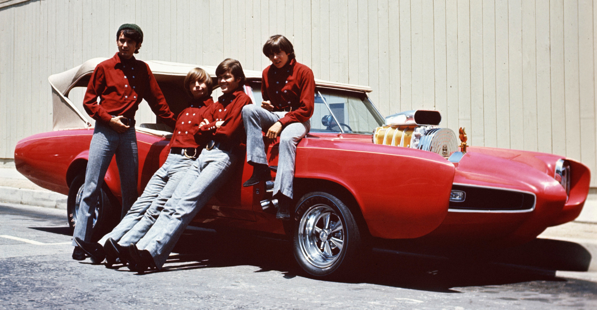 The Monkees Davy Jones, Michael Nesmith, Peter Tork and Micky Dolenz pose by Monkeemobile Pontiac GTO car for the 1960's TV show.