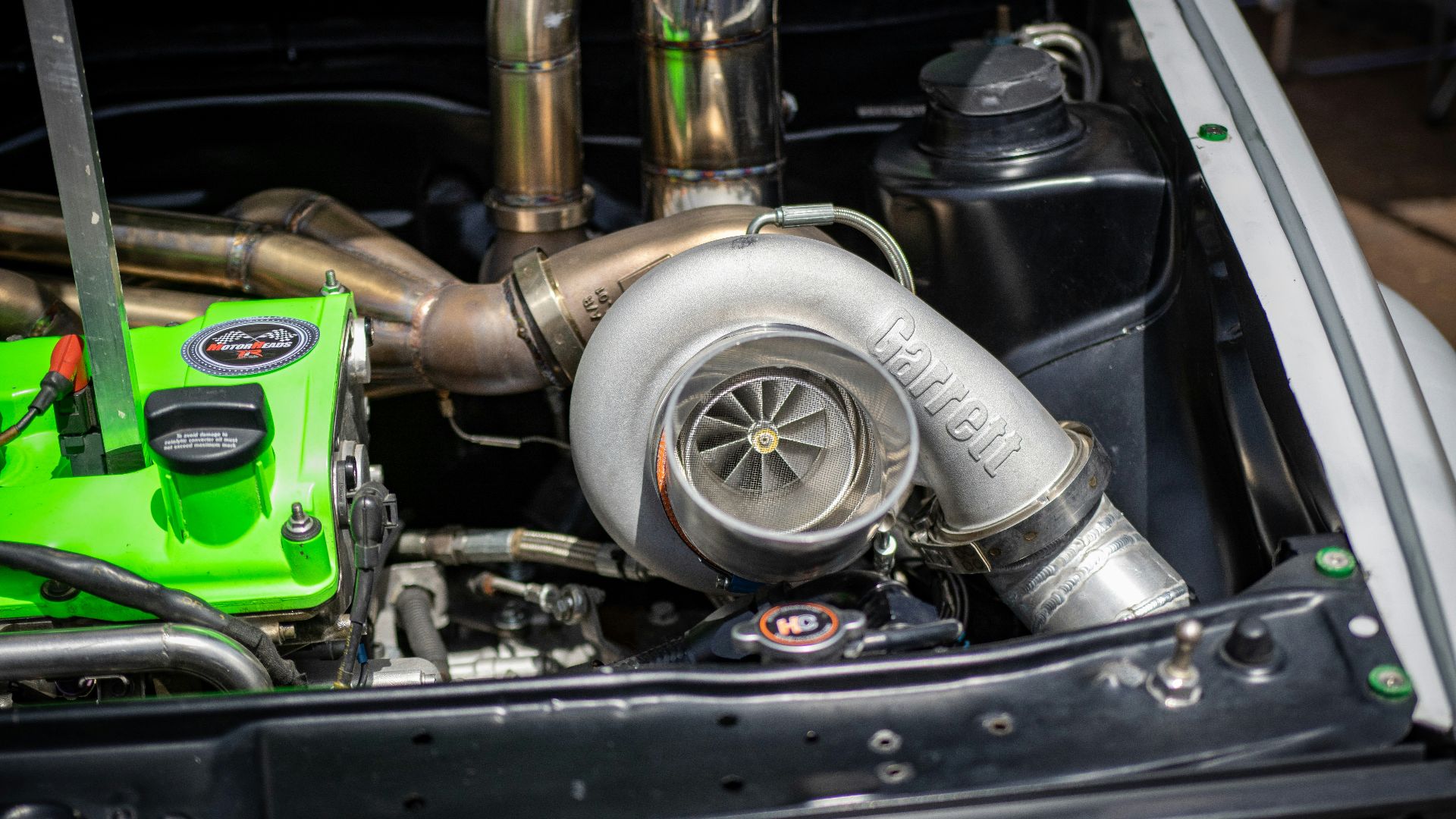 the engine compartment of a car with a green engine