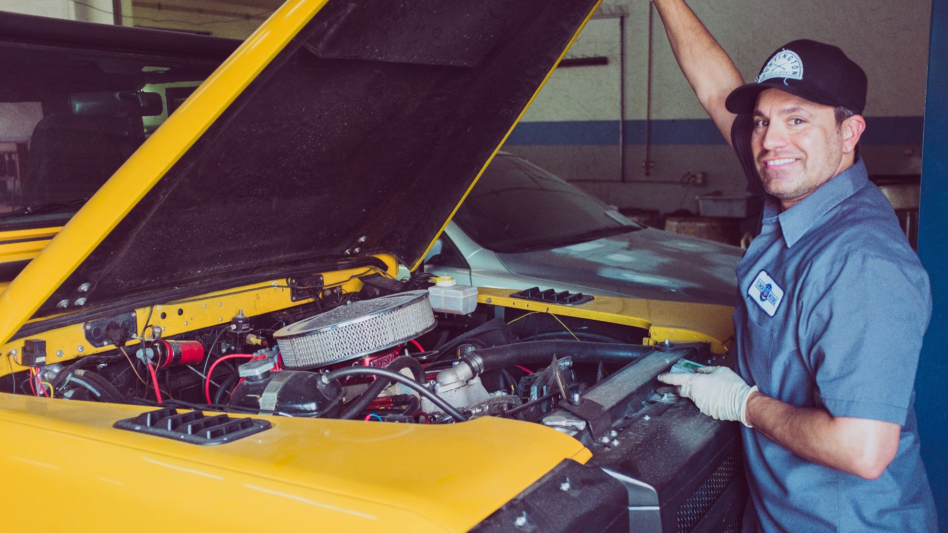 man holding open-wide car trunk