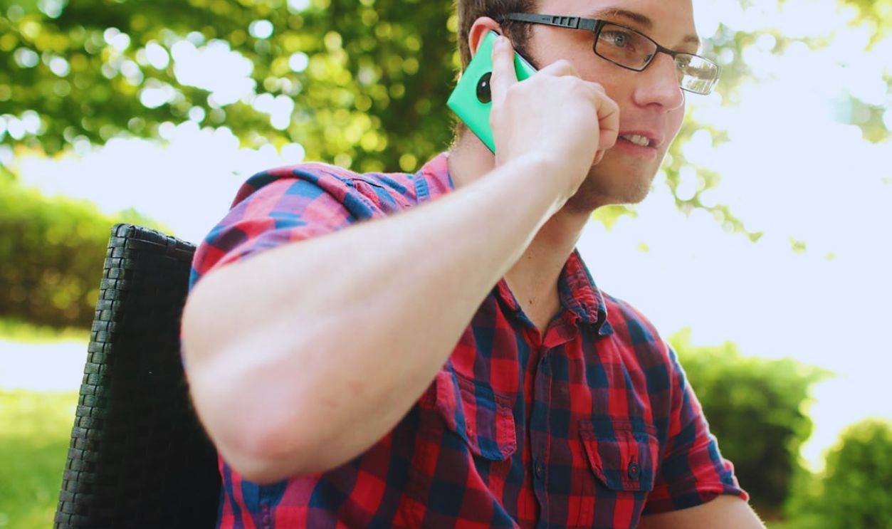 Man Placing His Phone on His Right Ear