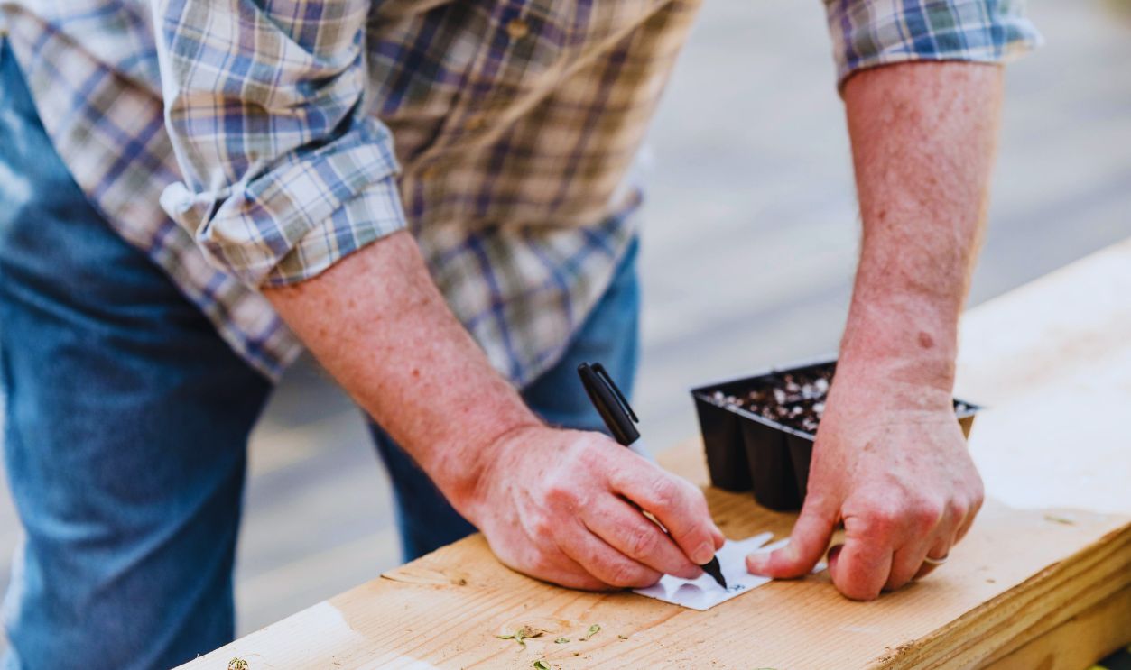 A Man Writing on a White Paper