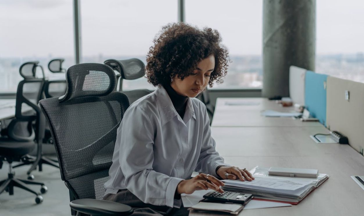 Woman Sitting at Table Working