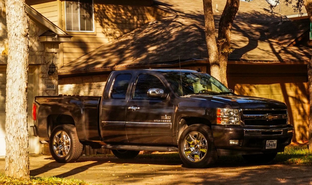 Black Pickup Truck Parked Near Suburban House