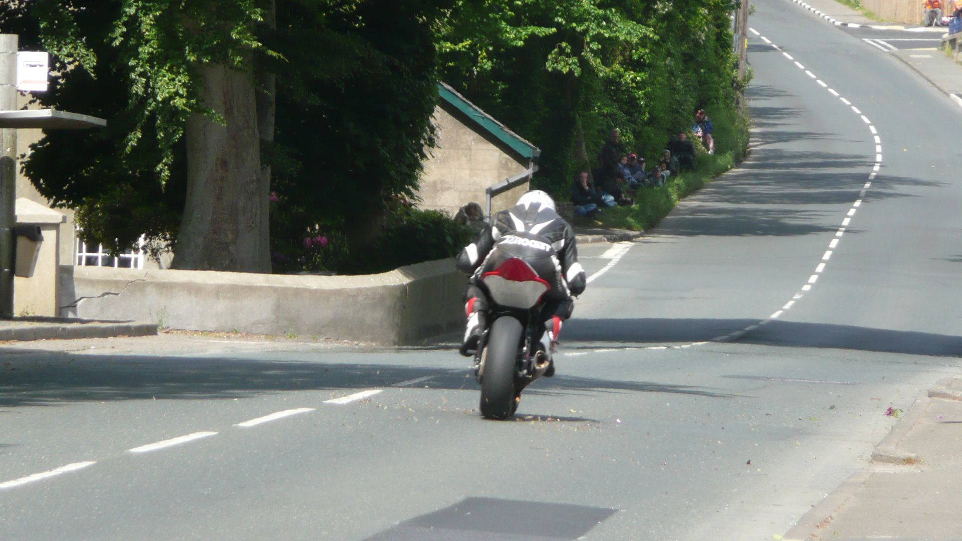 Unknown rider approaching Crosby Crossroads on the Isle of Man TT course during the Junior Supersport B TT race in 2008