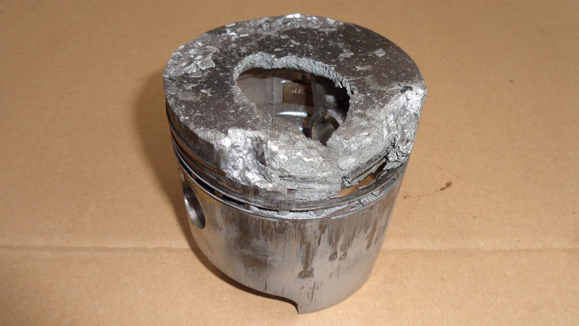 burnt piston: fuel injection jet failed - burning temp. went up and destroyed the piston. From the collection of horrors by C. Richter.