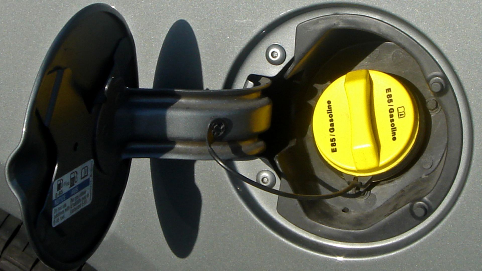 Typical label and yellow gas cap used American models to identify E-85 flexible-fuel vehicles. Miami, US. Shown a GM Impala.