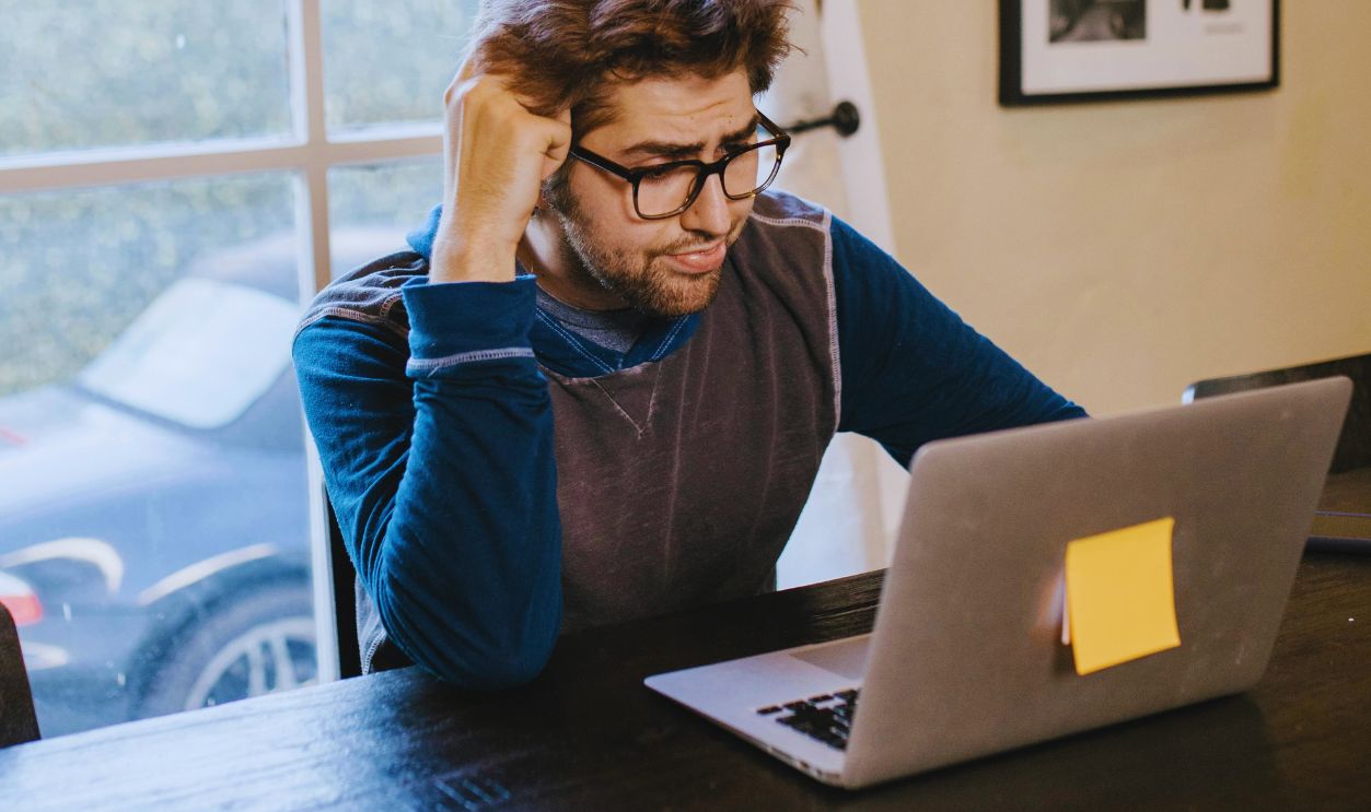 A Man Sitting in Front of a Laptop