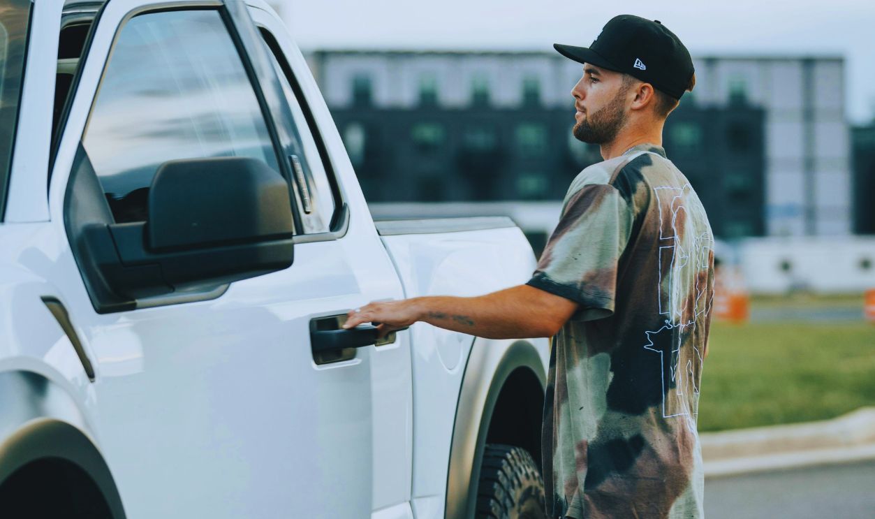 Man Opening the Door of a Vehicle