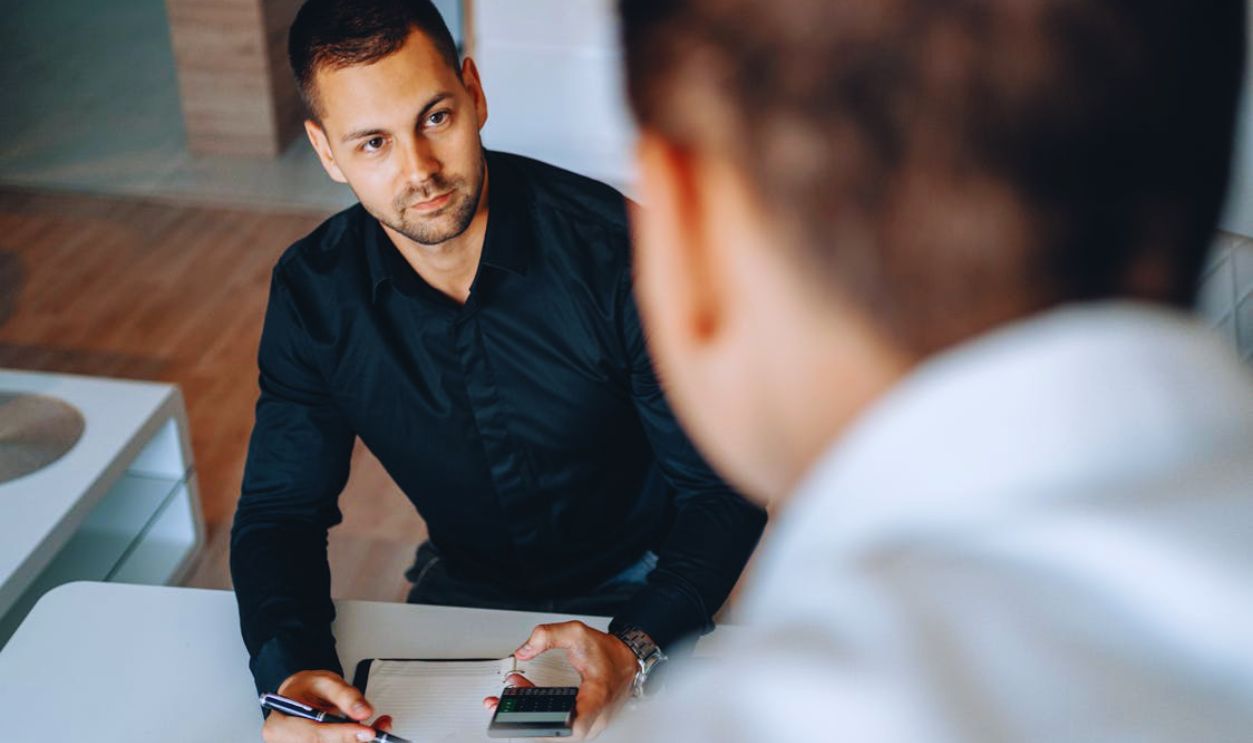 Man in Black Long Sleeve Using Smartphone