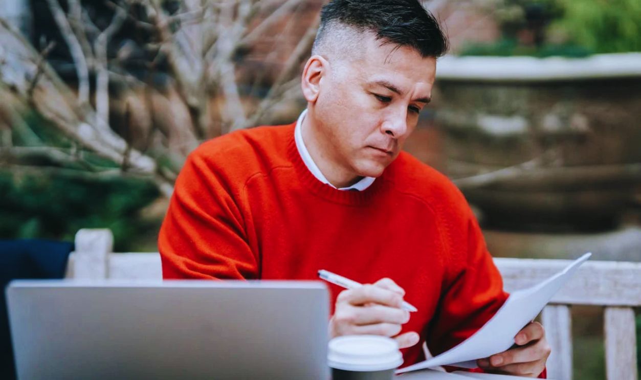 Photo Of Man Reviewing Documents