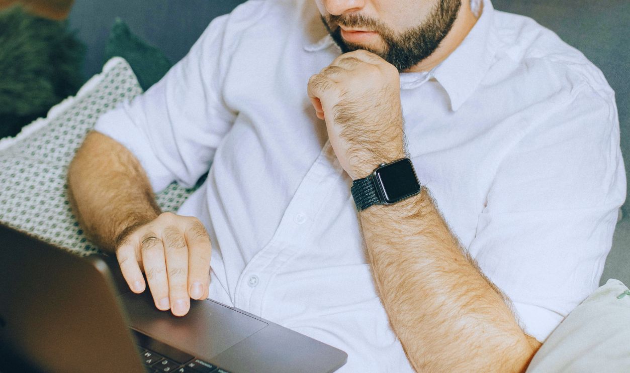 A Man using a Laptop while Sitting on Couch