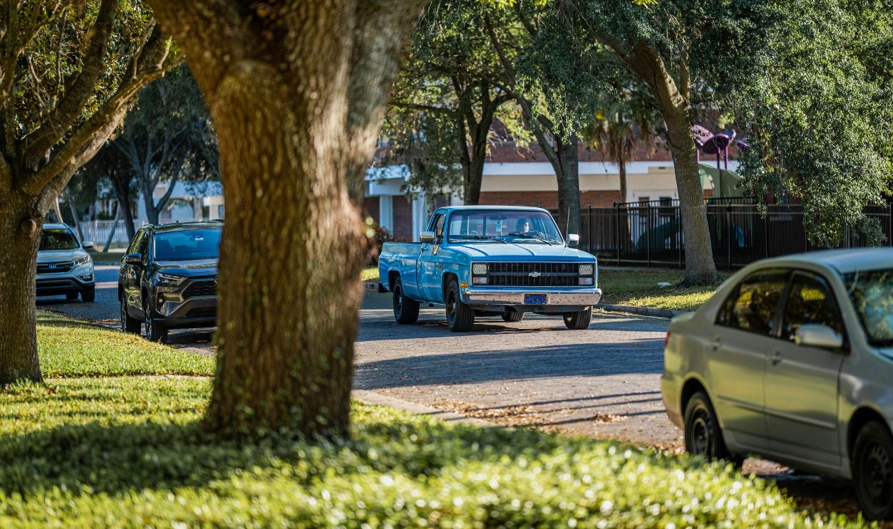 A group of cars driving down a street