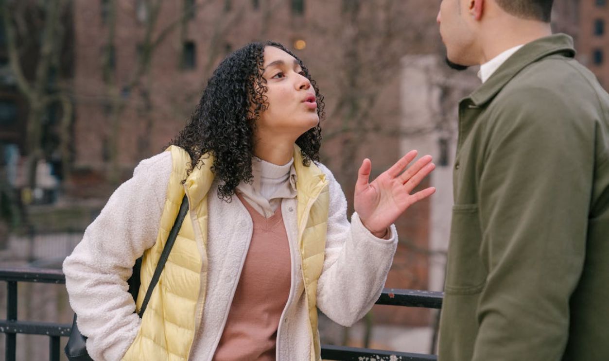 Young ethnic couple arguing on street
