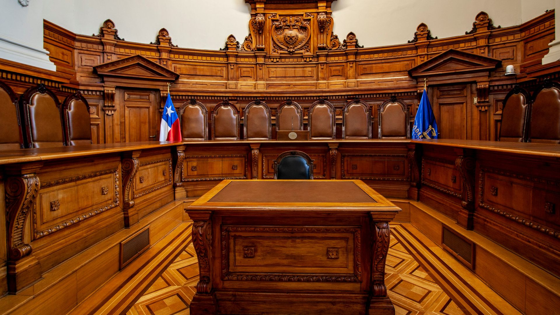 a courtroom with a large wooden bench