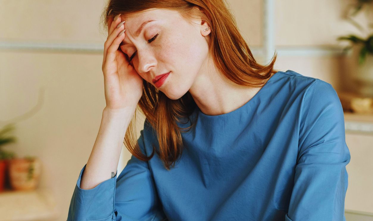Exhausted Woman Working with Laptop