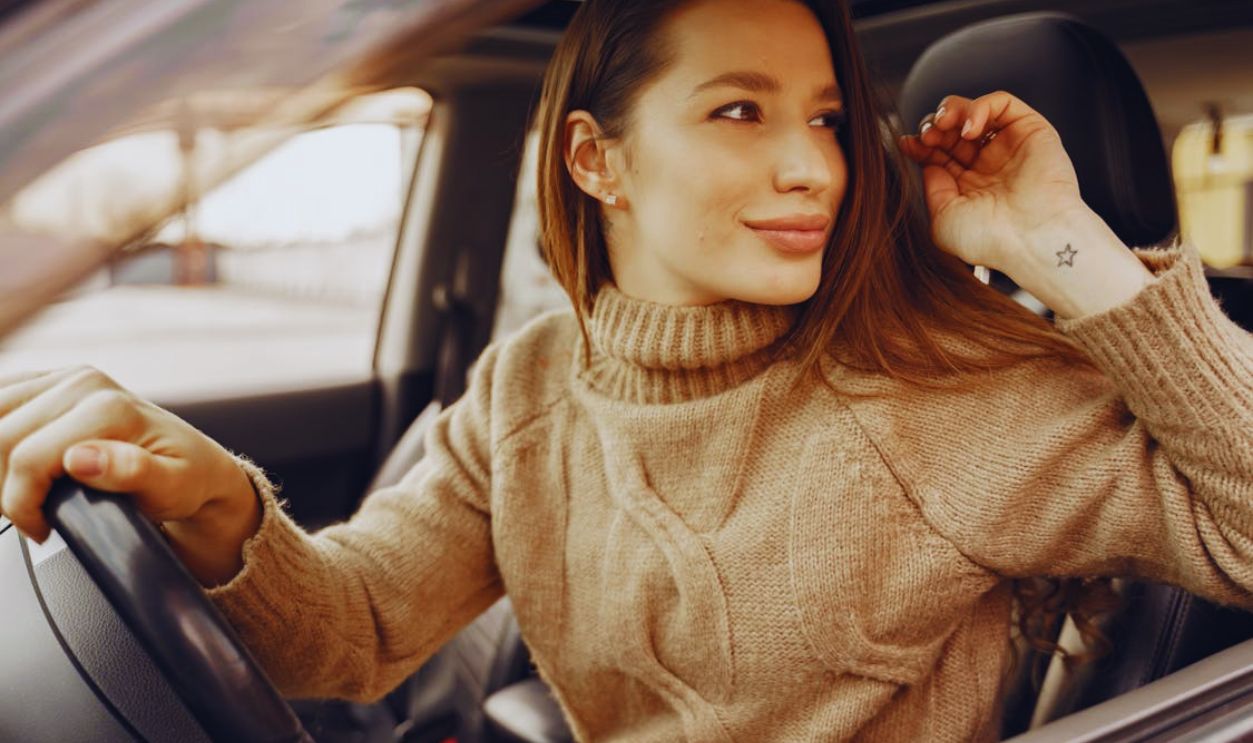 Smiling woman in driving seat of modern car