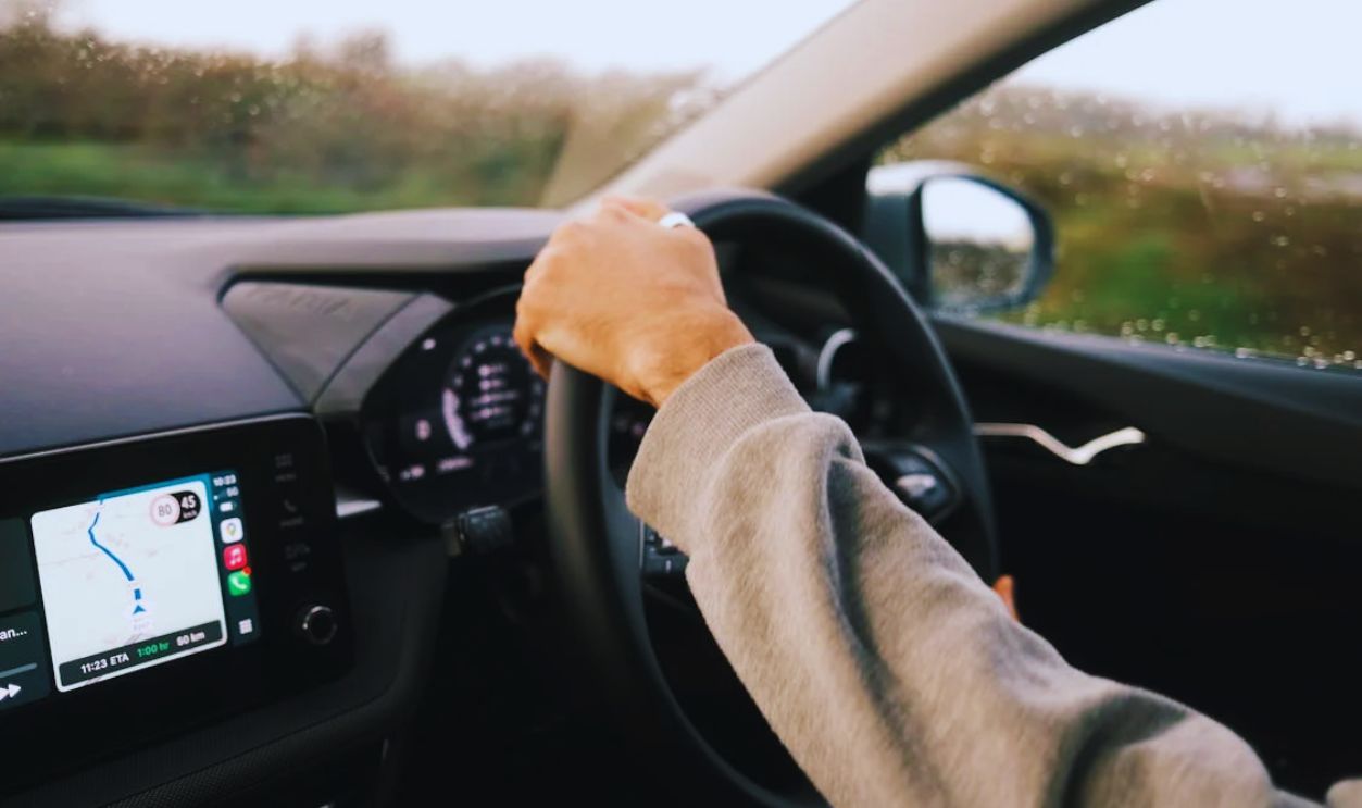 Driver navigating wet roads with GPS assistance