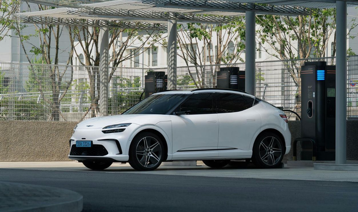 White Electric SUV Charging at Outdoor Station