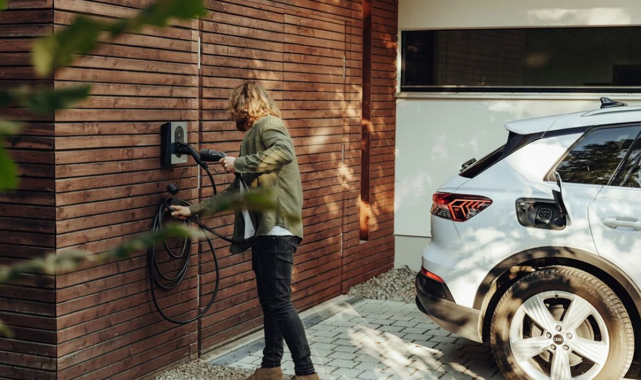 a woman is using a power washer on a brick wall
