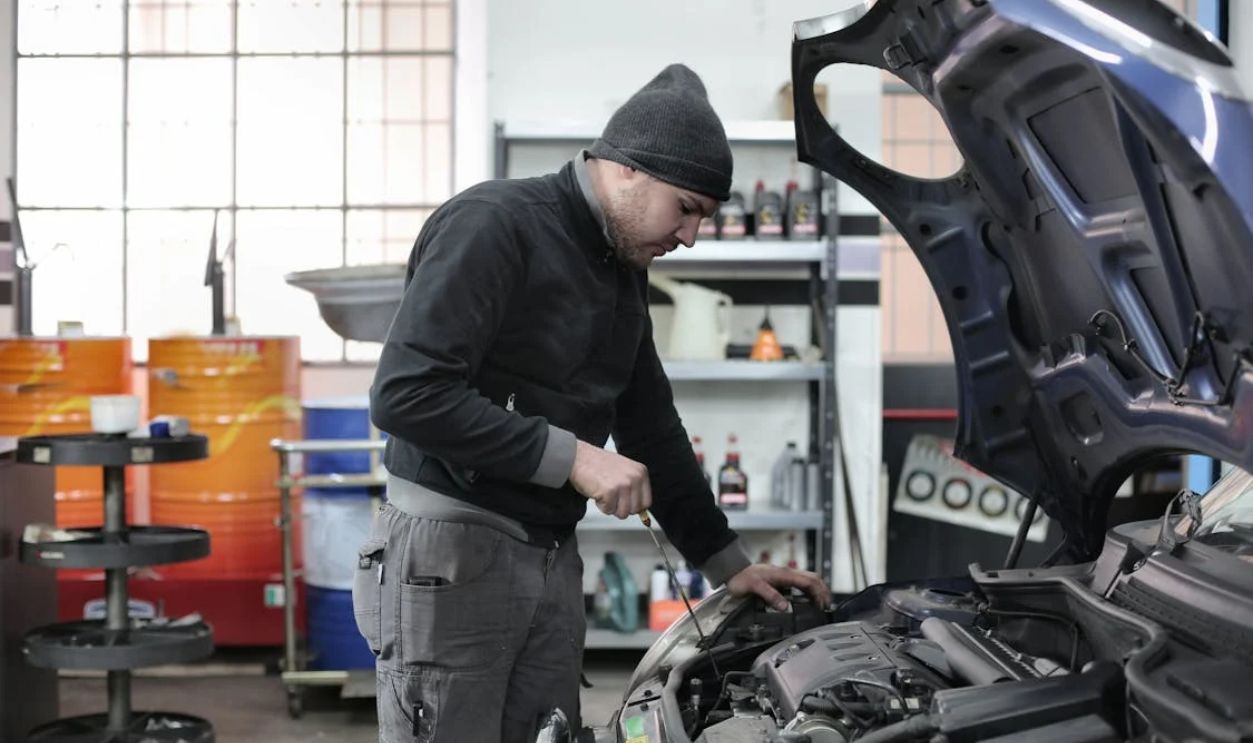 Photo of Man Inspecting Car Engine