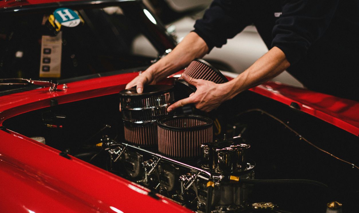 A Person Putting Air Filter in the Car