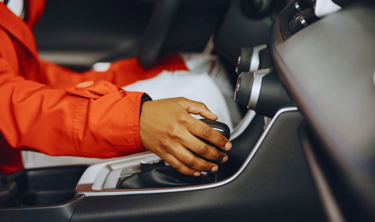 Hand of a Person Operating the Gearshift While Driving
