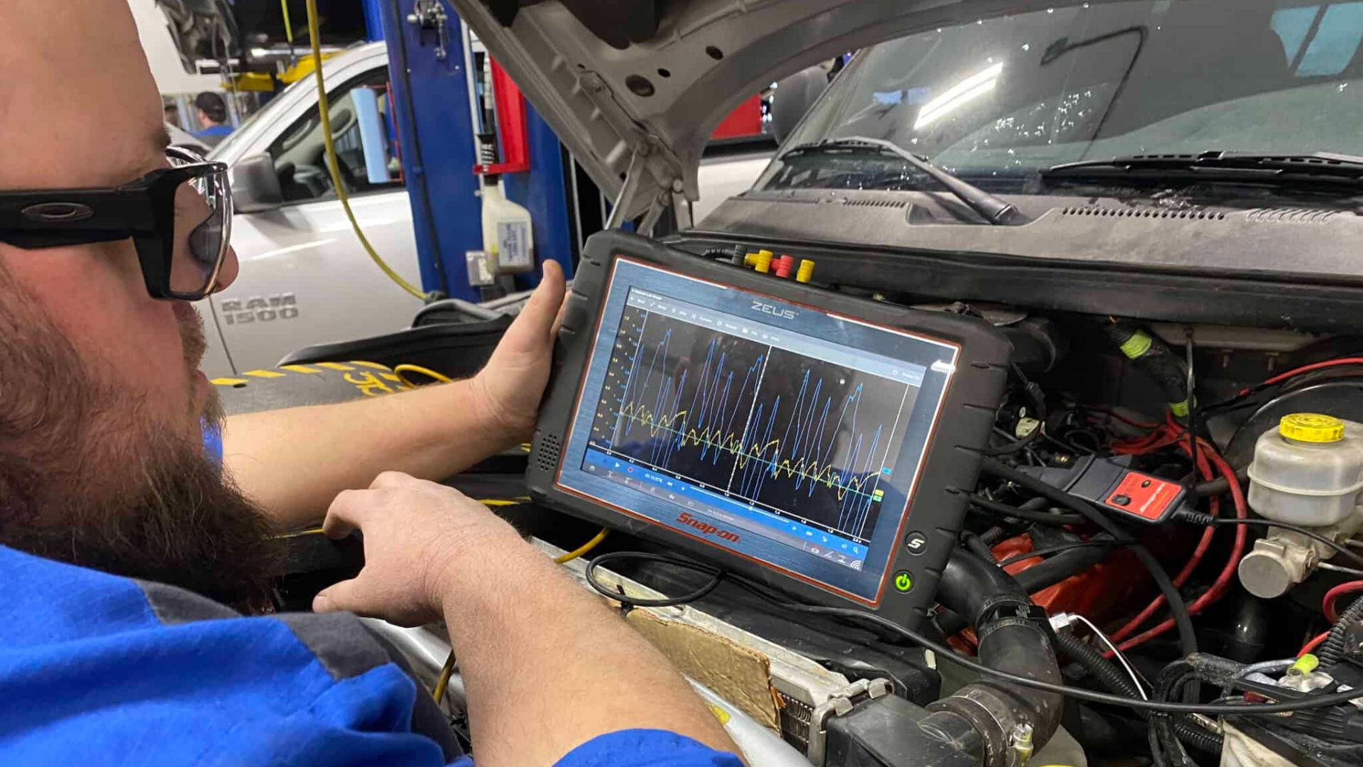 A man is diagnosing a electronic vehicle system