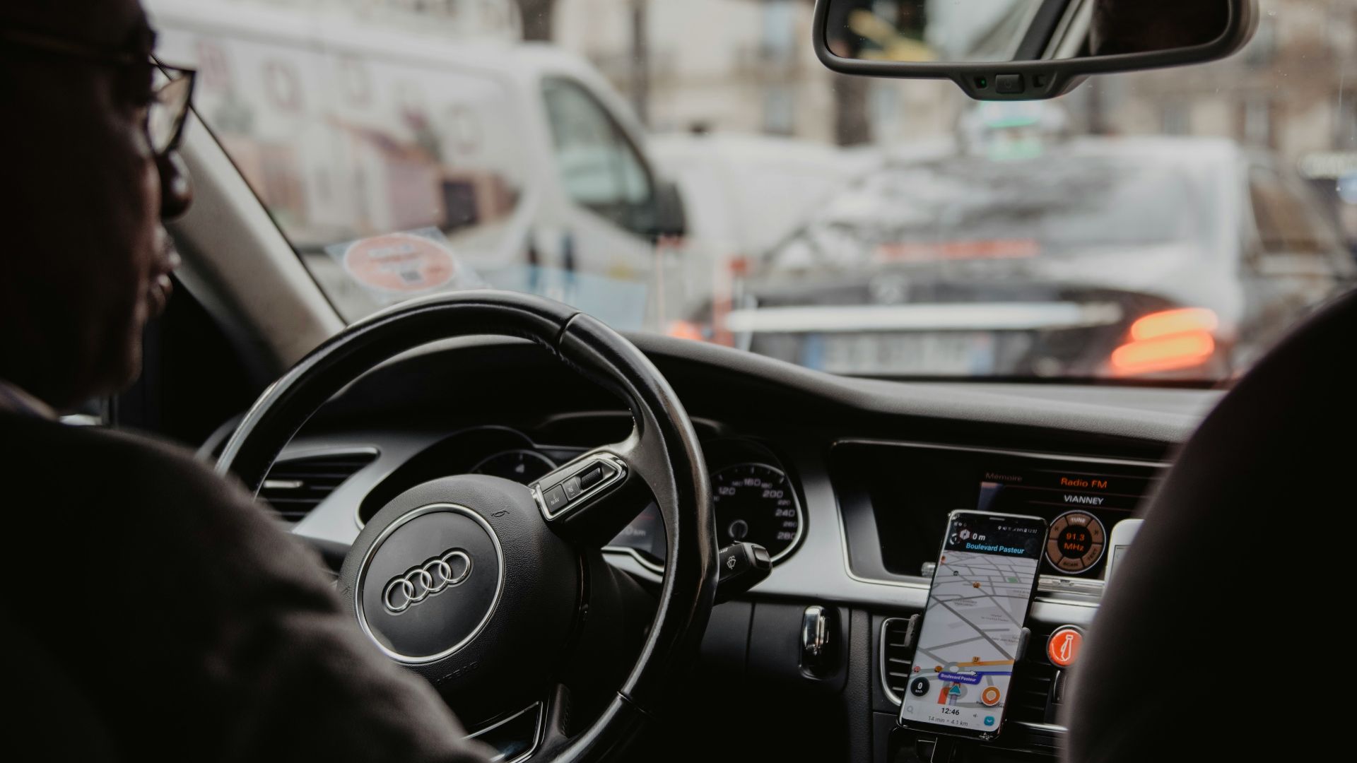 man in black jacket driving car during daytime