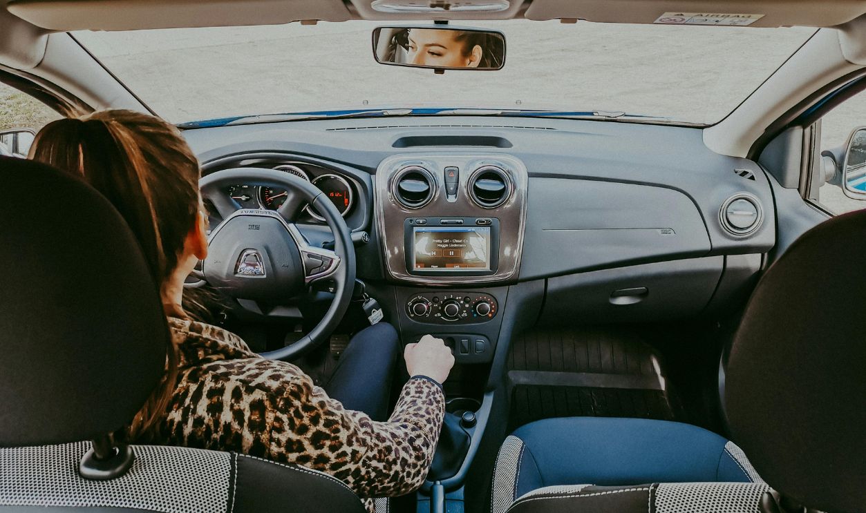 Woman driving modern car along