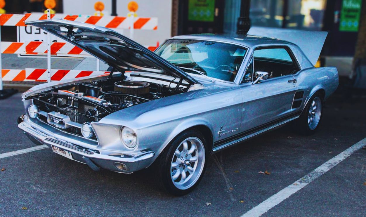 Classic Ford Mustang with Open Hood at Car Show