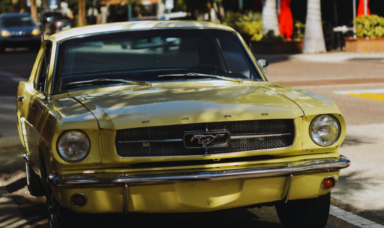 Vintage Yellow Mustang Parked on Sunny Street