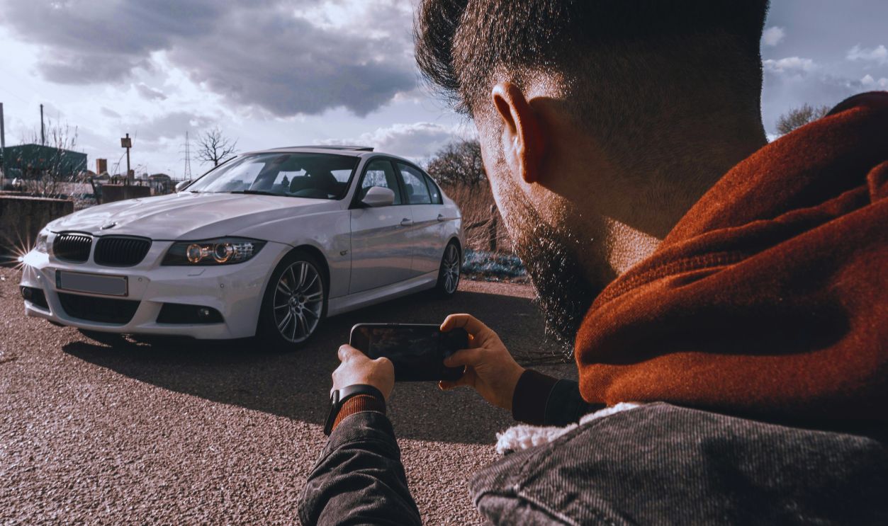 man taking car photo