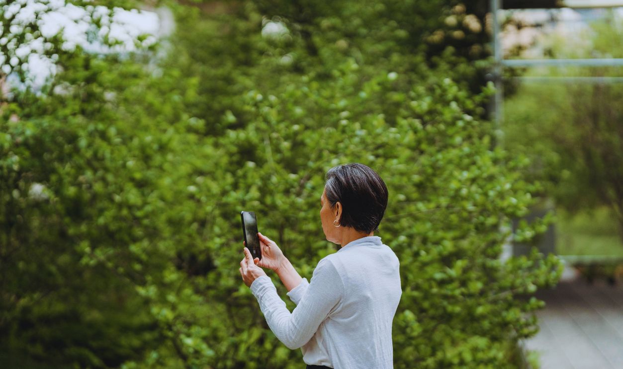 Woman Taking Photos Using Her Smartphone
