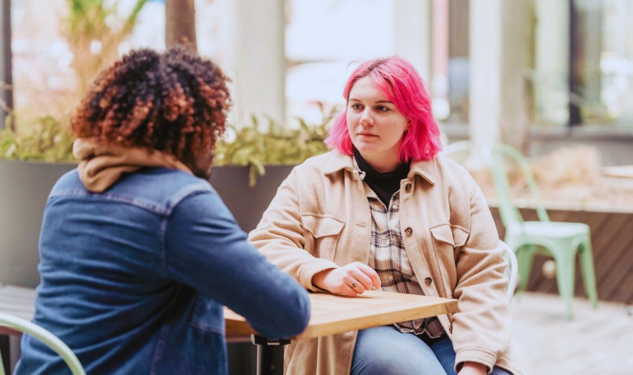 Diverse friends sitting at cafe table