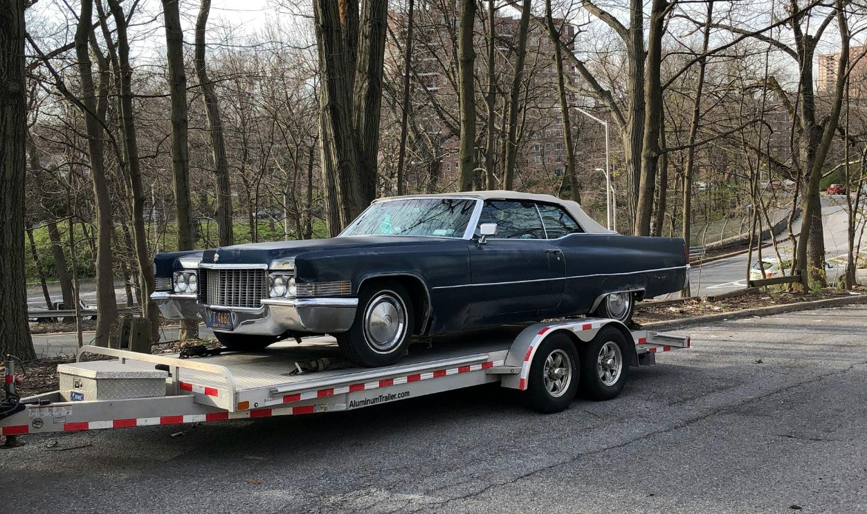 Blue Car on White Tow Truck