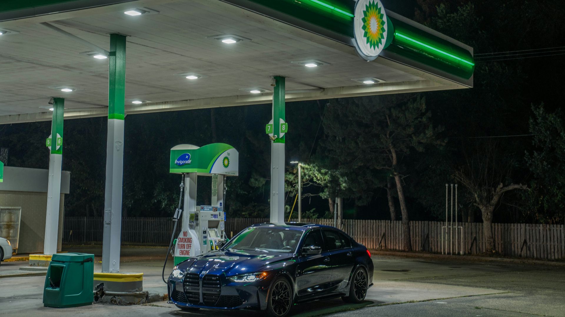 A car at a bp gas station at night.