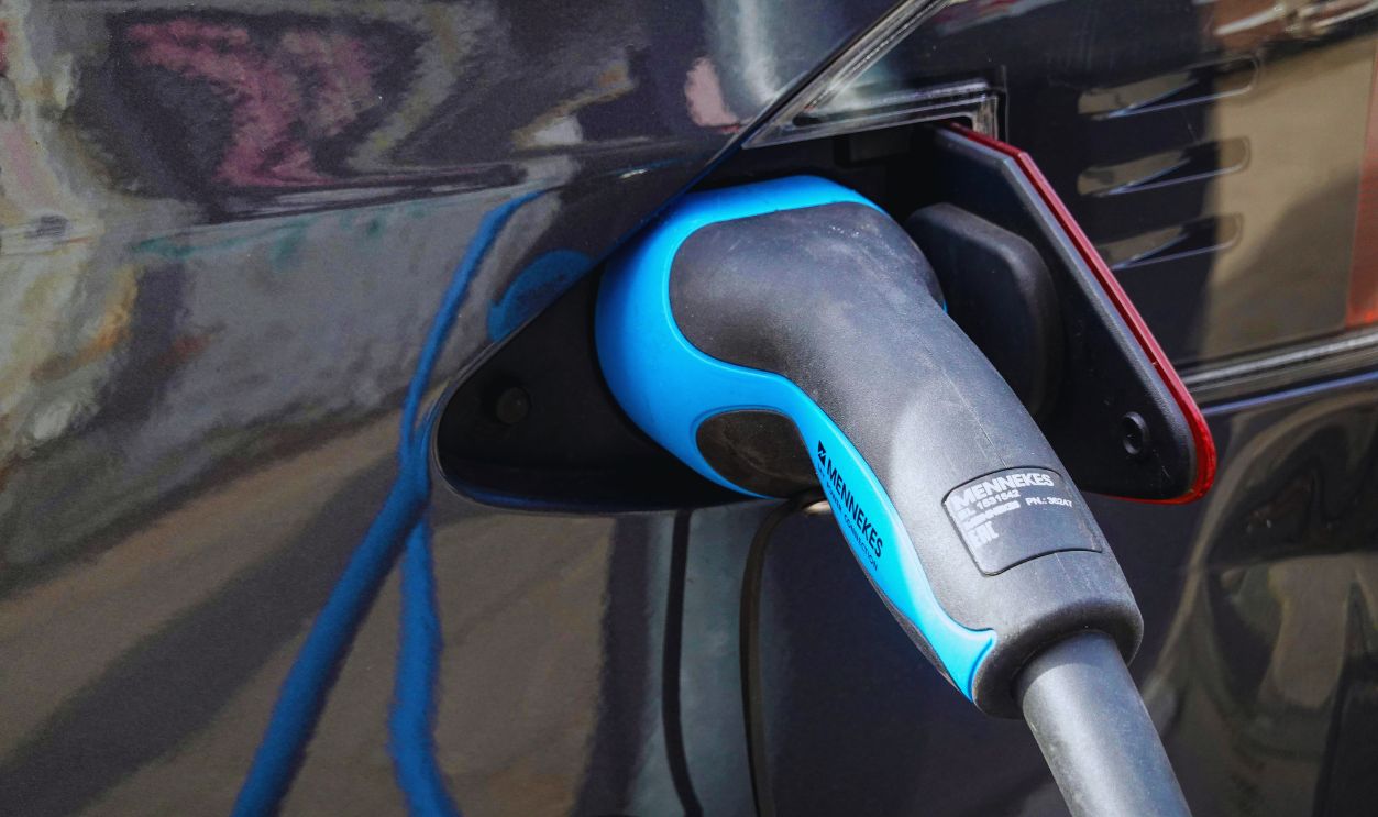 A Blue and Black Gas Pump Nozzle in a Vehicle Gas Tank