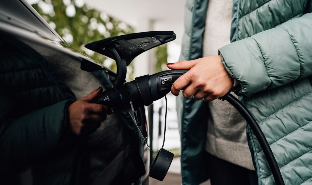 Someone is plugging in an electric car to charge