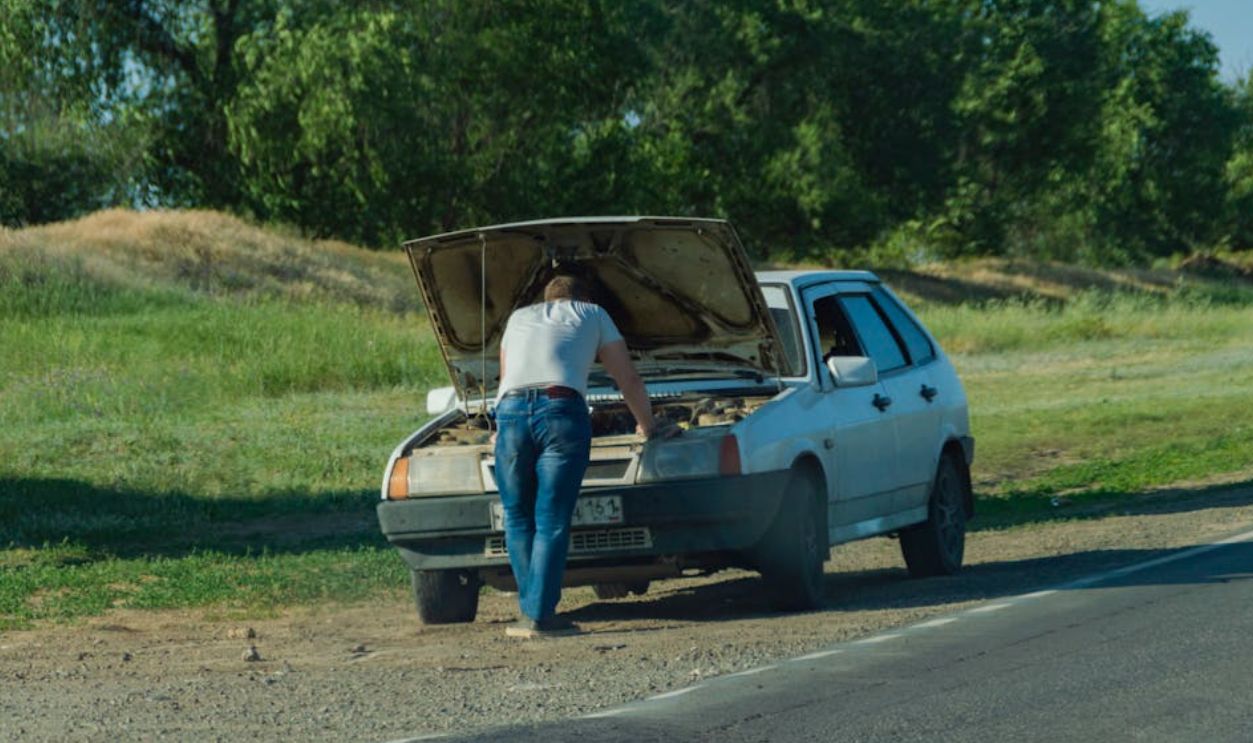 A Man Having Car Problems on the Roadside