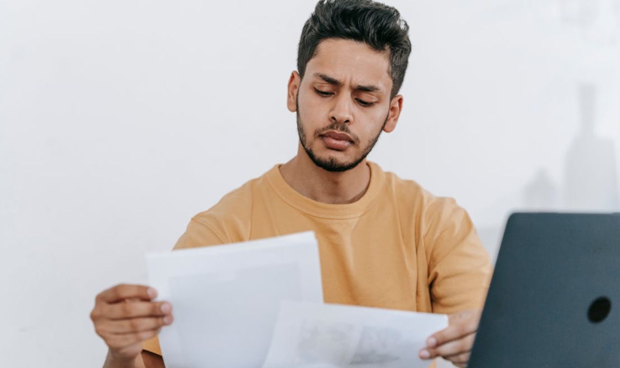 Man looking through documents at workplace