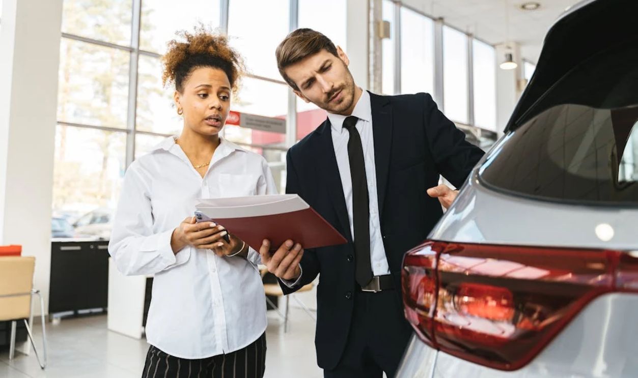 A Woman Talking to a Car Dealer