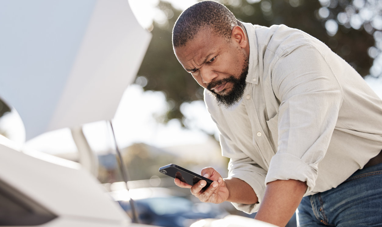 Breakdown, cellphone and black man by car